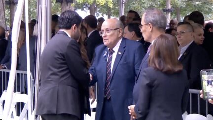 mam and giuliani shake hands at 9/11 memorial