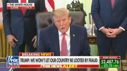 Trump seated in the oval office during a press conference